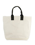 Beige tote bag with black handles on a white background