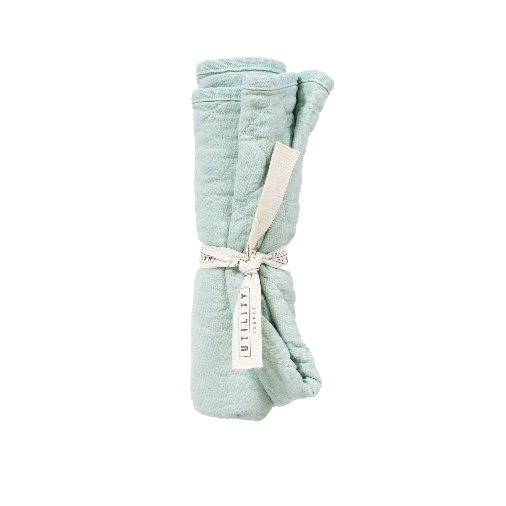 Folded light blue floor mat with a label on a white background