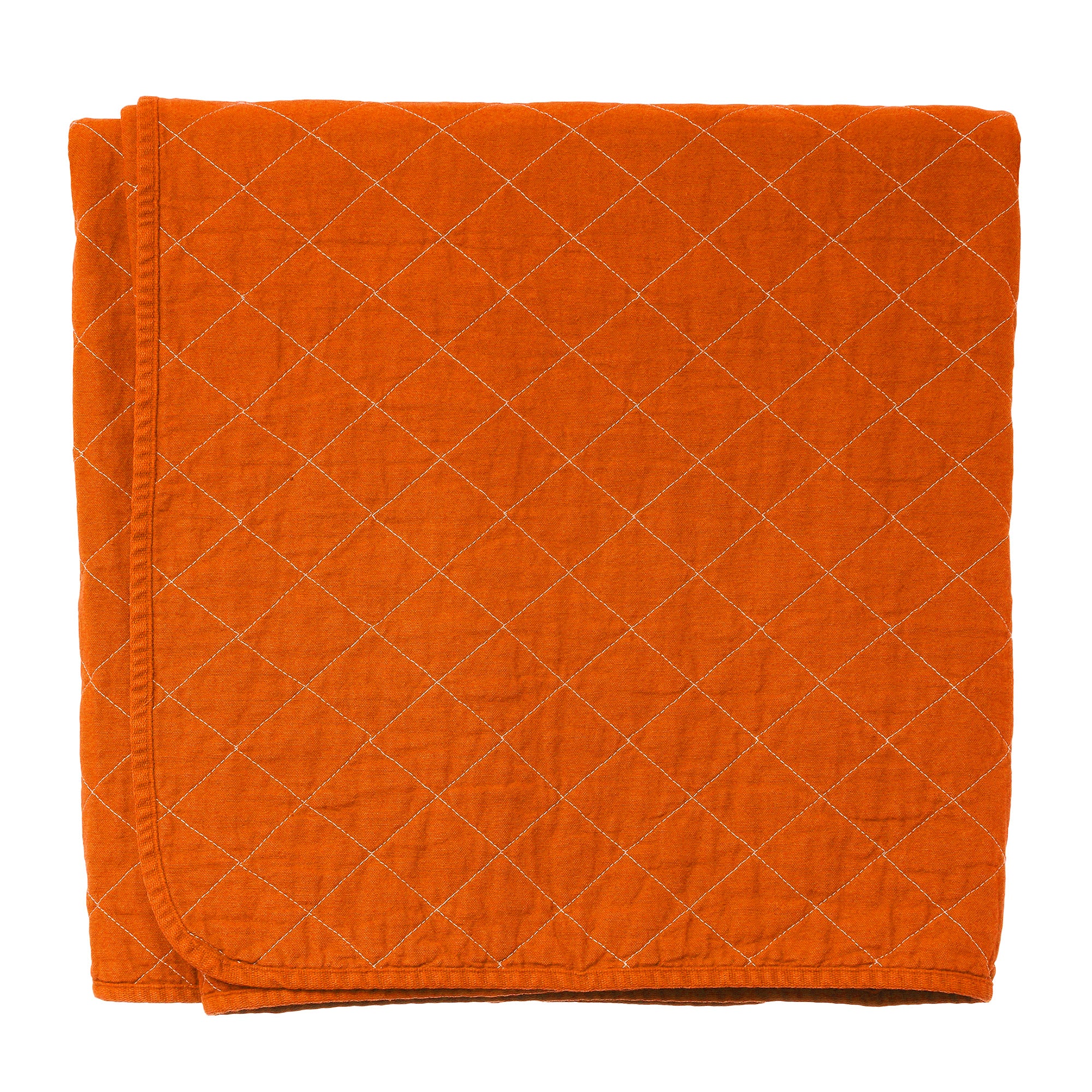 Orange quilted blanket on a white background